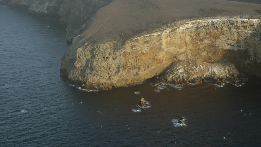 Waves gently crash on a rocky shoreline
