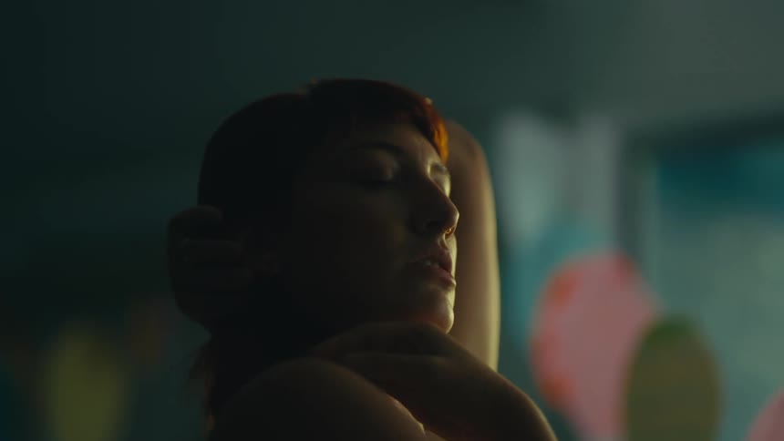Redhead woman with closed eyes dancing