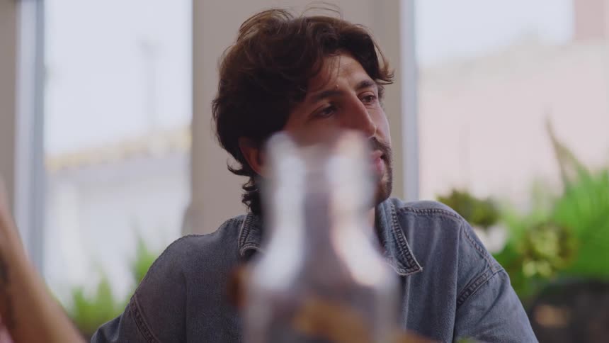 Portrait of a man next to a woman sitting at a table talking