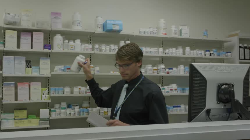 A pharmacist is working in a pharmacy