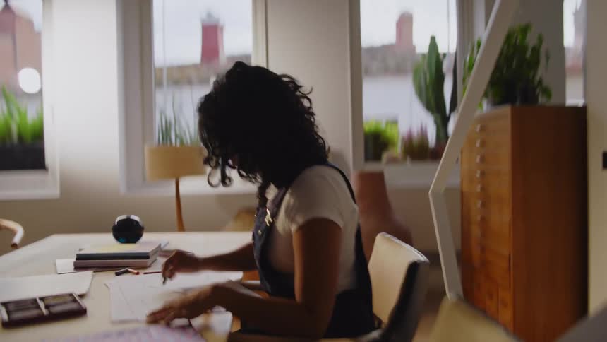 Woman illustrator sitting drawing in fast motion