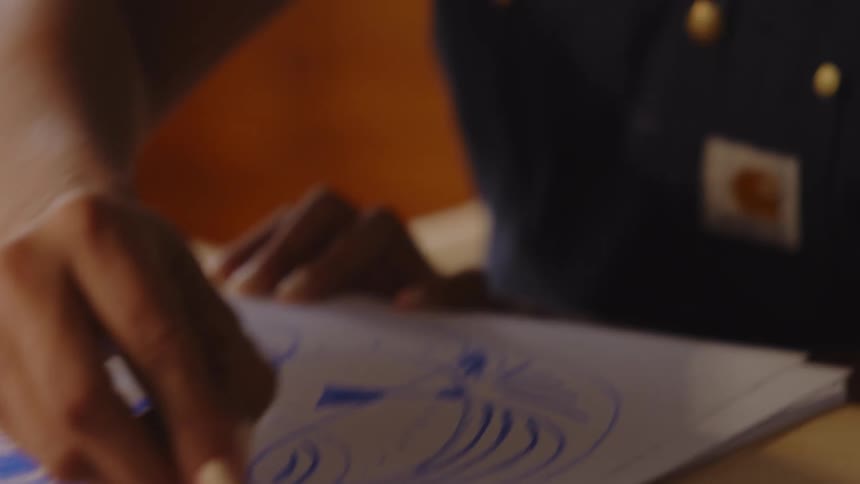 A clip of a lady drawing a sketch