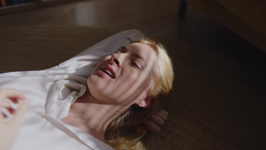 A woman is laying on the ground talking