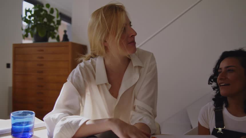 Two women talk at the desk