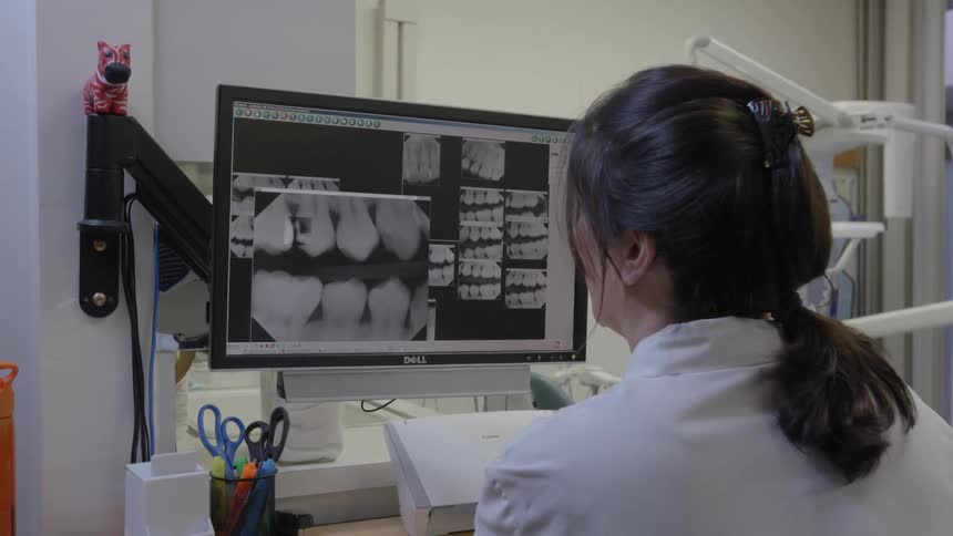 Technician looking at dental x-rays