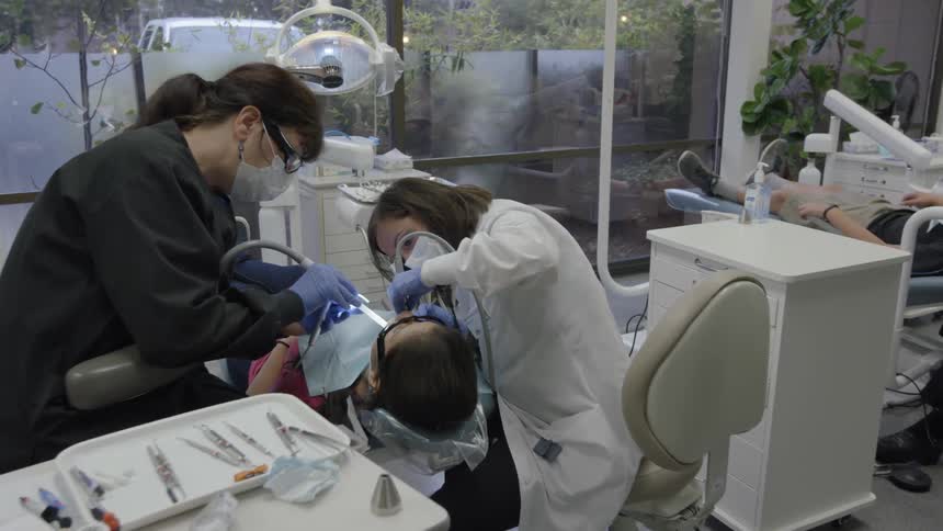 Dentists are working on patients in a dental office