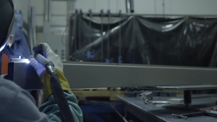Man welding in a shop area
