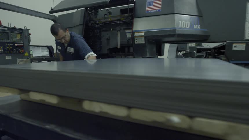 Man working metal plates in a metal factory