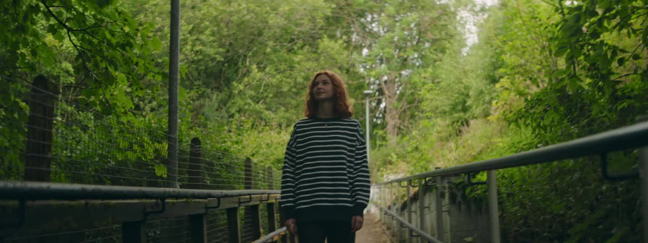 A clip of a lady walking in a park