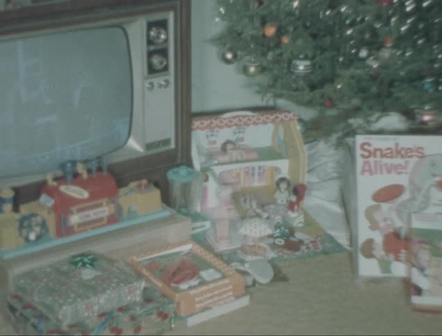 Christmas morning scene of presents near a christmas tree captured on vintage film