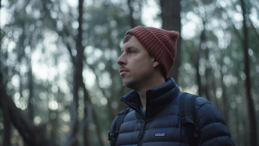 Portrait of a man with a red cap in a forest