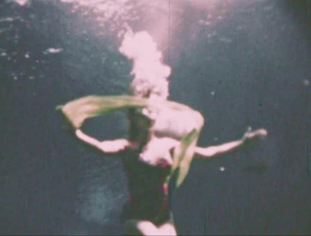Woman dancing submerged in the water