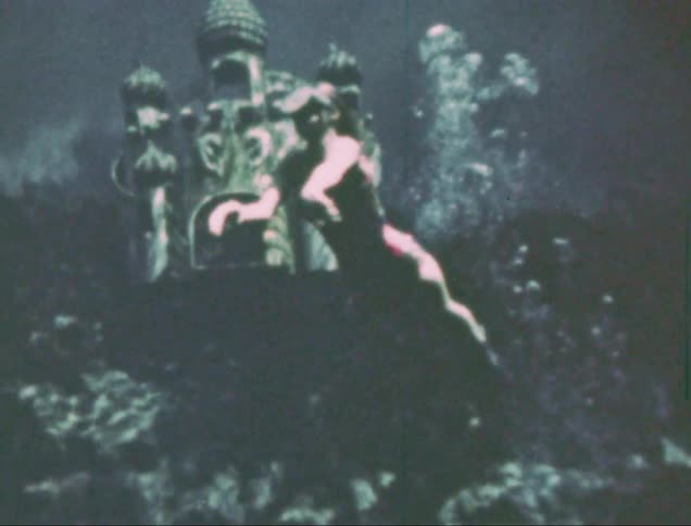 A weeki wachee mermaid performing underwater captured on vintage film