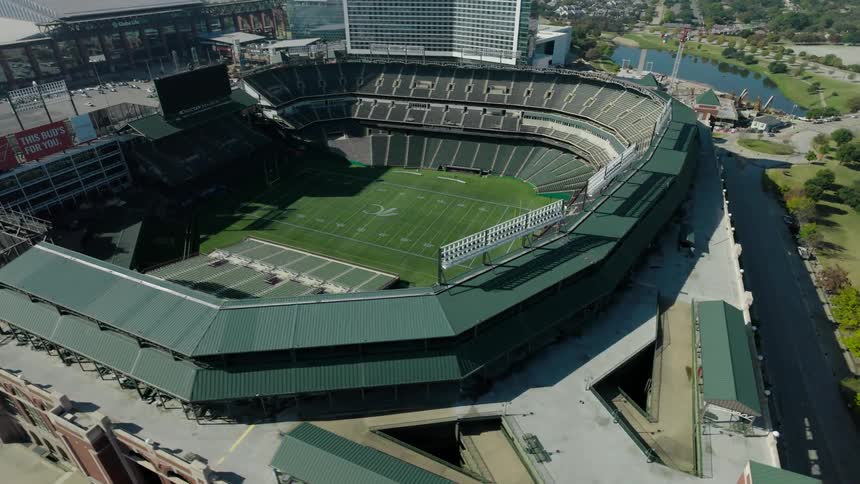 Aerial view of a large stadium on the edge of a lake in a city