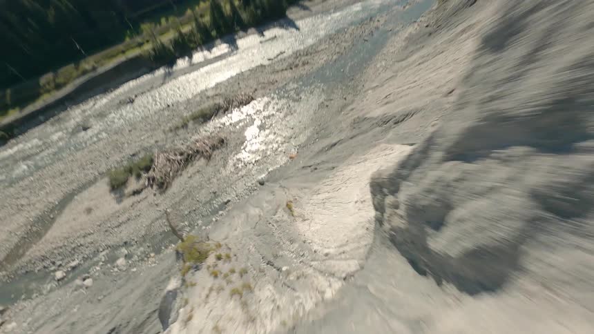 Aerial view of cliffs and a rocky river on a mountainous landscape in Switzerland