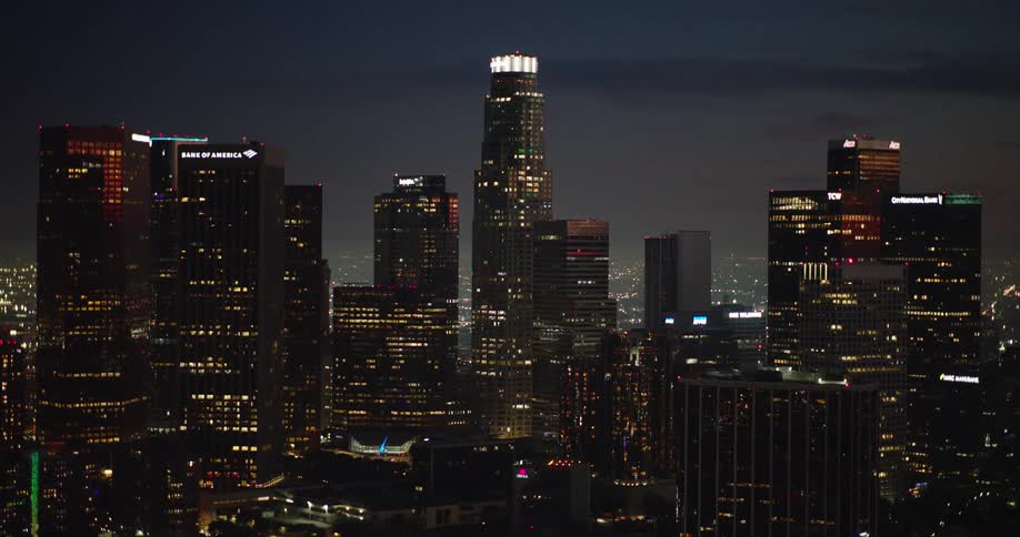 Large skyscrapers shine with lights in a city at night
