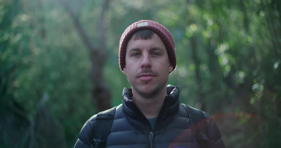 Portrait of a man in a headdress in a forest during the day