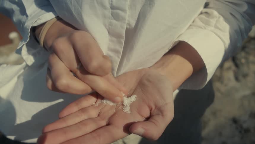Close up of a womans hand with salt