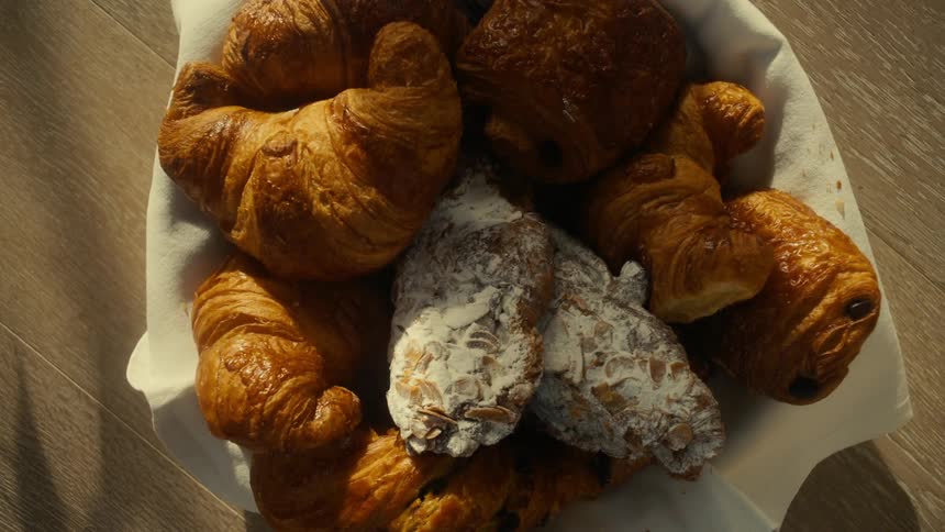 Croissants arranged in a basket on a table