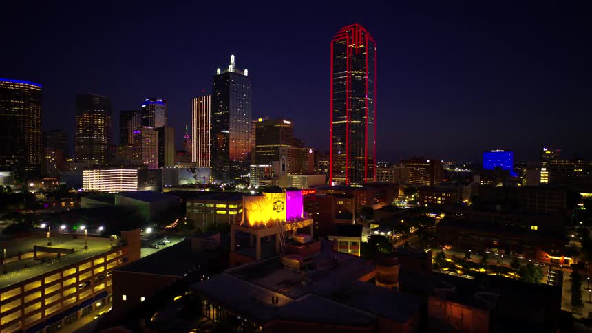 Aerial of a brightly lit skyscraper at night