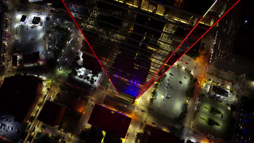 Aerial of a skyscraper with red lights at night