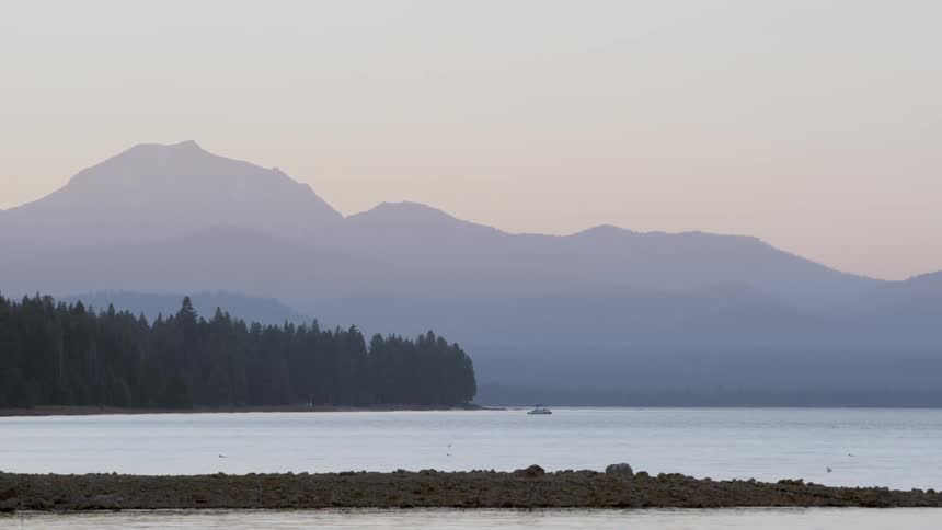 A rock jetty in the ocean at sunset