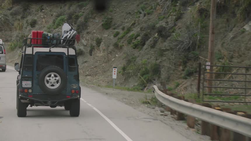 Jeep following another vehicle on a two lane winding road
