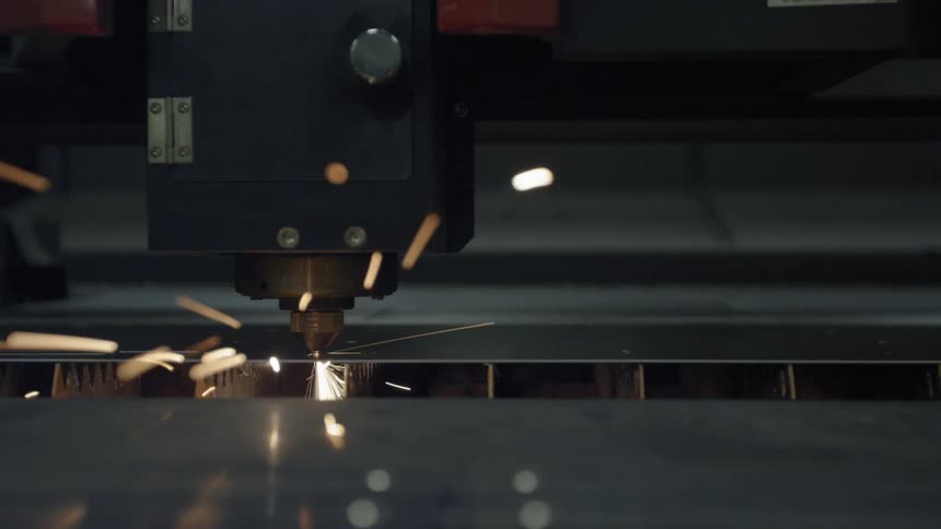 An industrial machine is cutting a sheet of metal