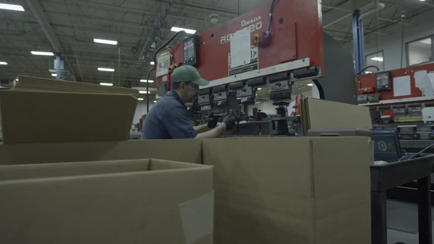 Man performing his work at a workstation in a factory