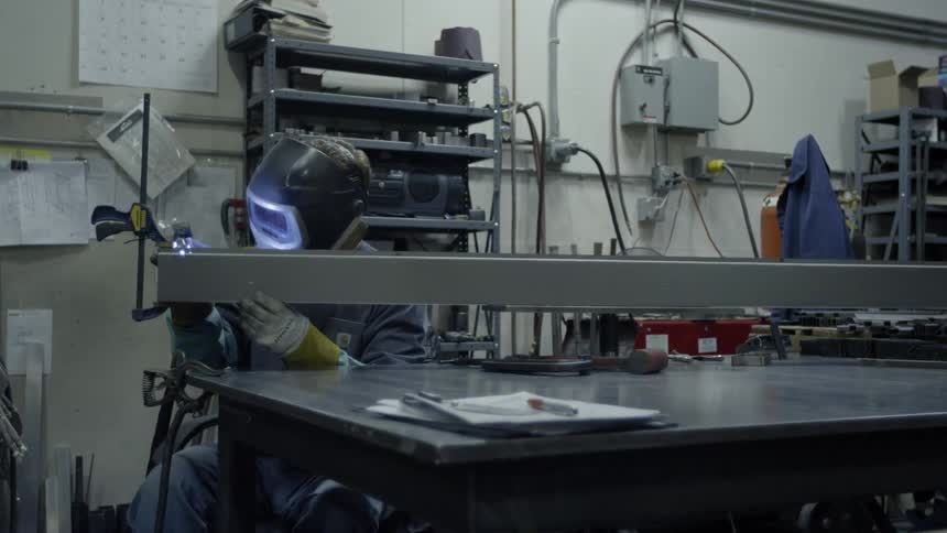 A person is working with a torch in a workshop