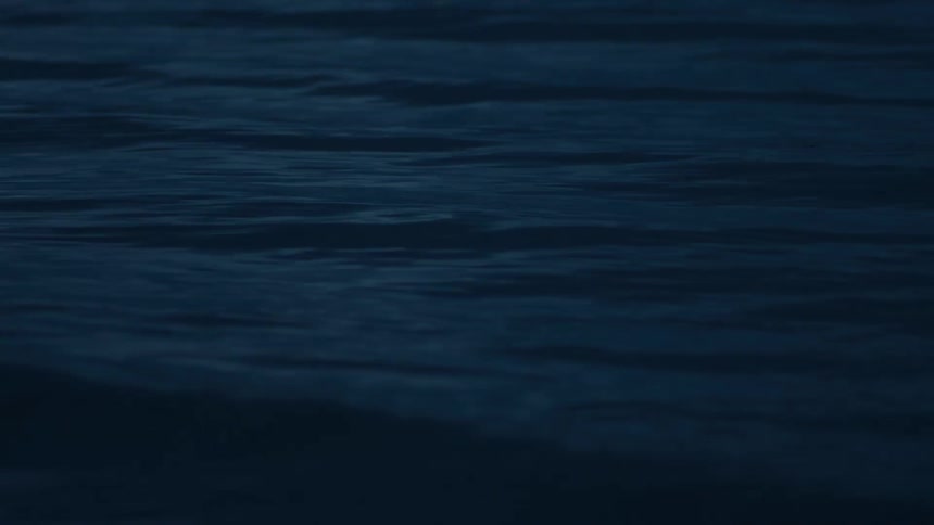 Small waves flow across the surface of the ocean