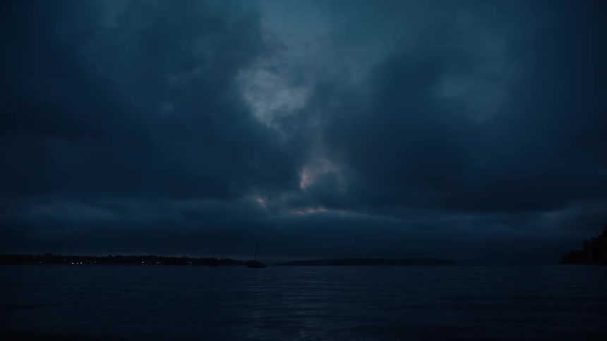 Seascape against a dark and cloudy twilight sky