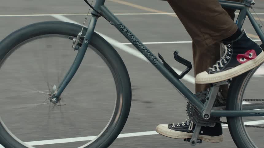Legs of a person riding a bicycle