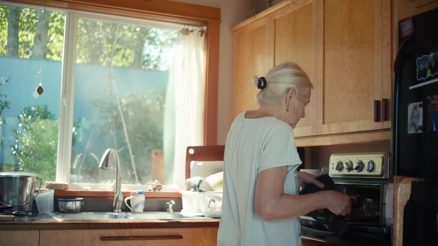 A woman is cooking in the kitchen