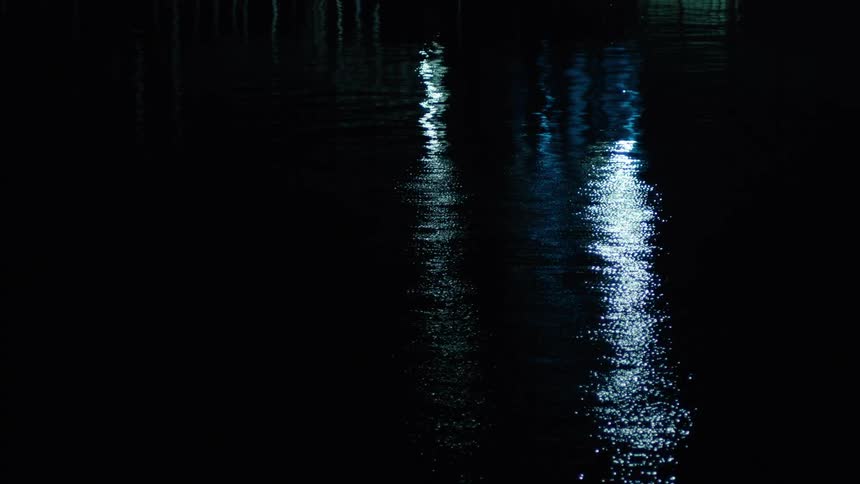 Lights reflecting on a lake at night