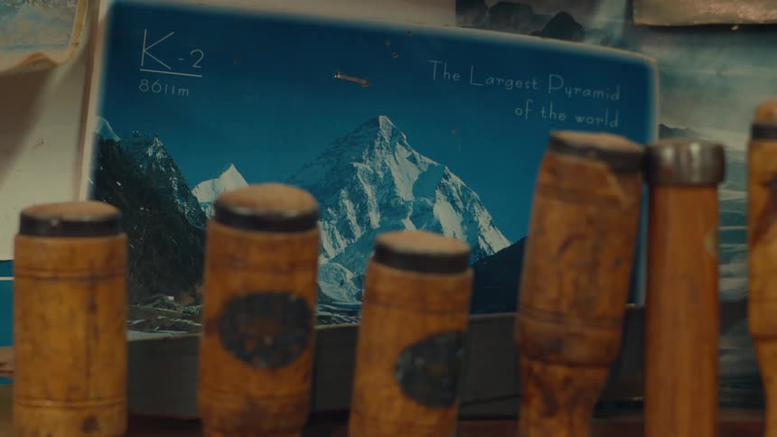 Closeup of carpenters tools and in the background a poster with an ice mountain