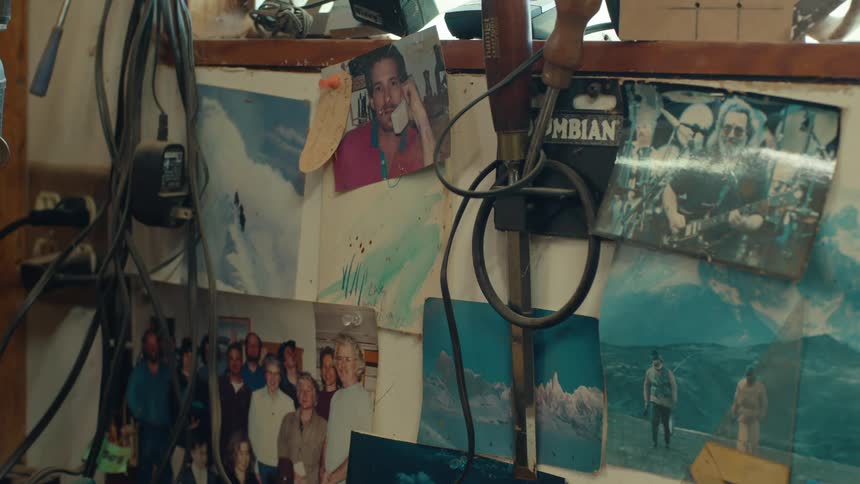 A wall full of photographs of different sizes of people in different situations