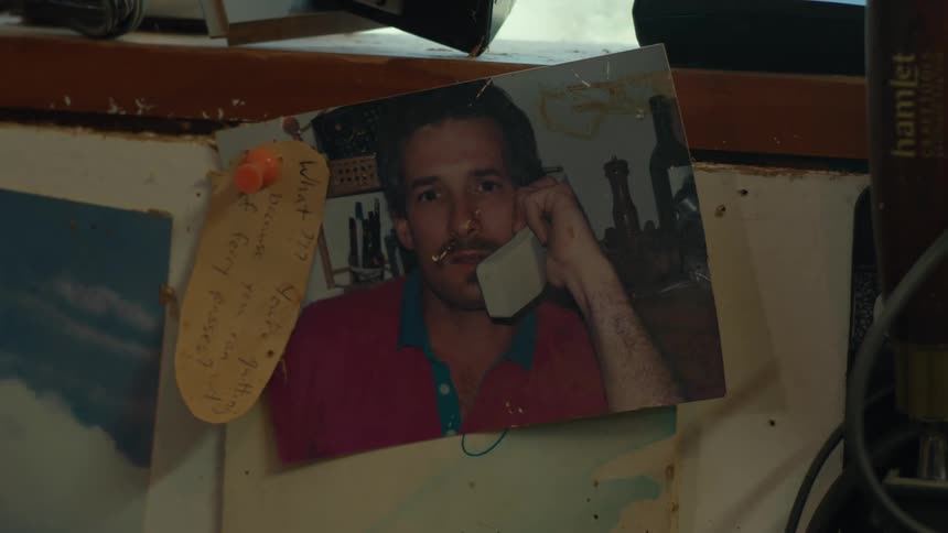 Photograph of a man on an old telephone