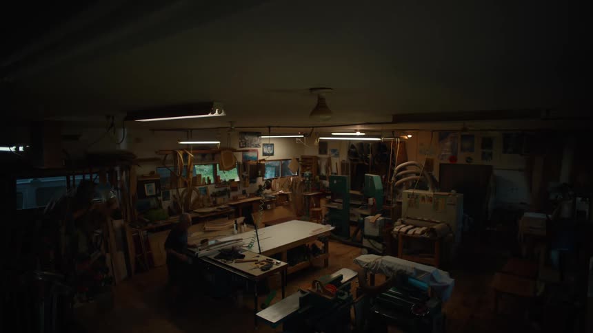 Older woodworker works in his workshop