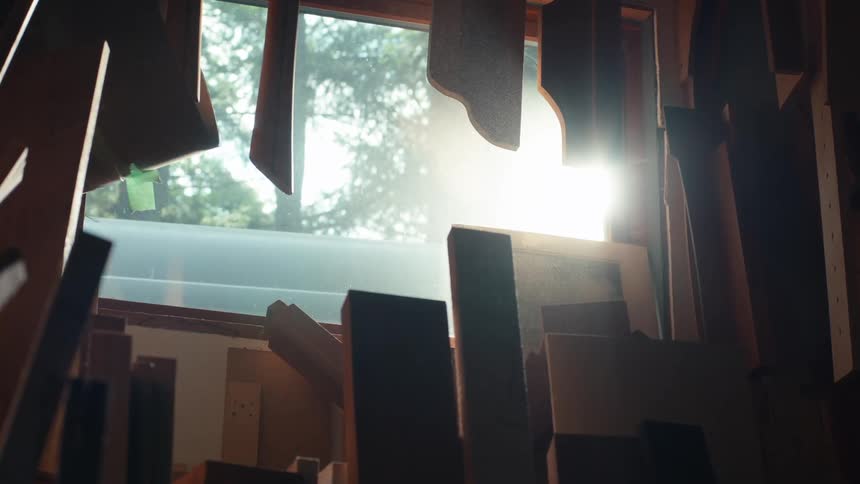 Planks of wood lean against the window