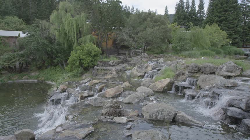 Water flowing over rocks and down into a pond like area