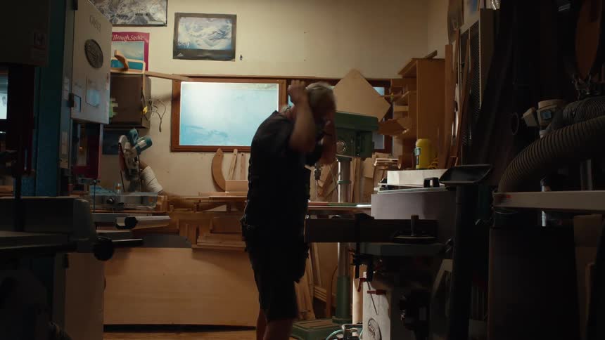 Carpenter man putting on a protective mask and working in an indoor space