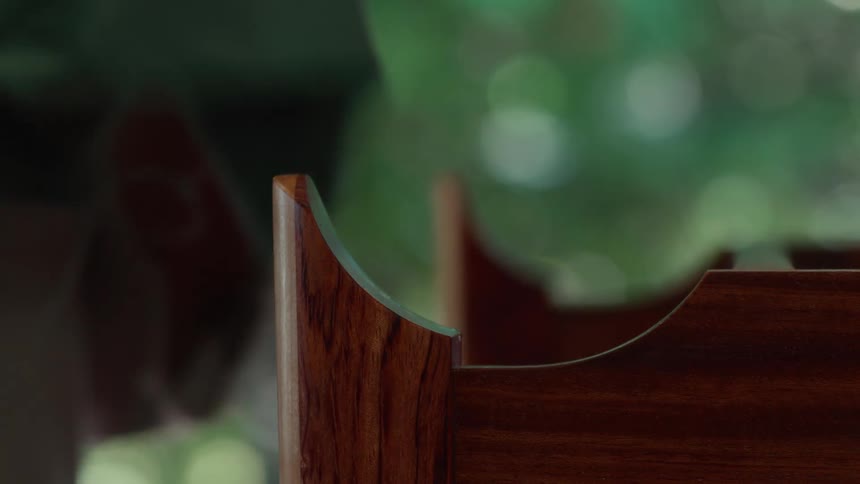 Person with a cloth next to varnished wood