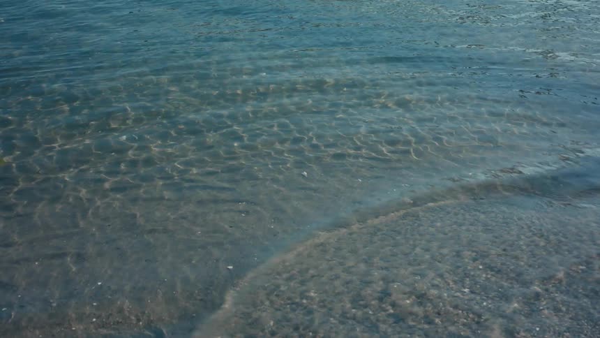 Calm waters close to the beach sand