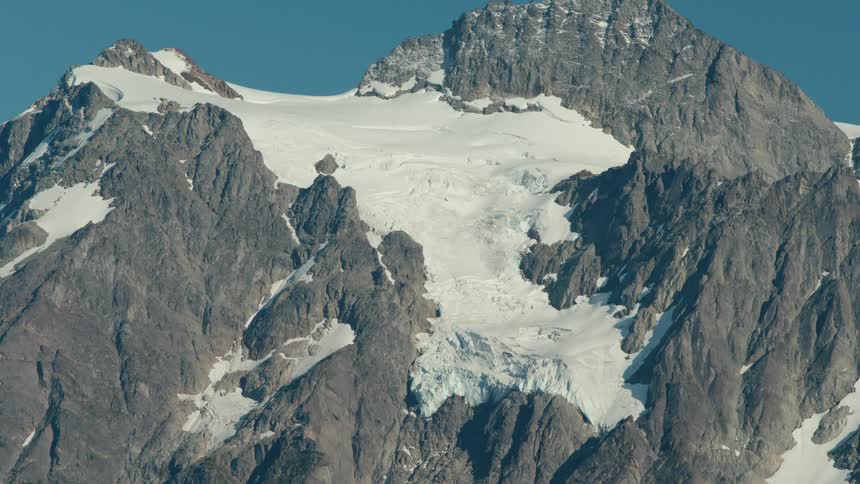 A glacier covers the top of a tall mountain