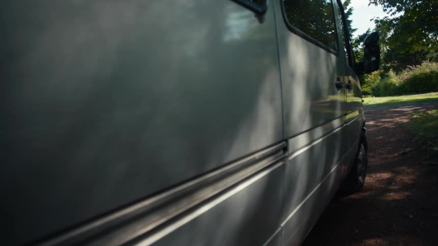 Side view of a parked silver minivan
