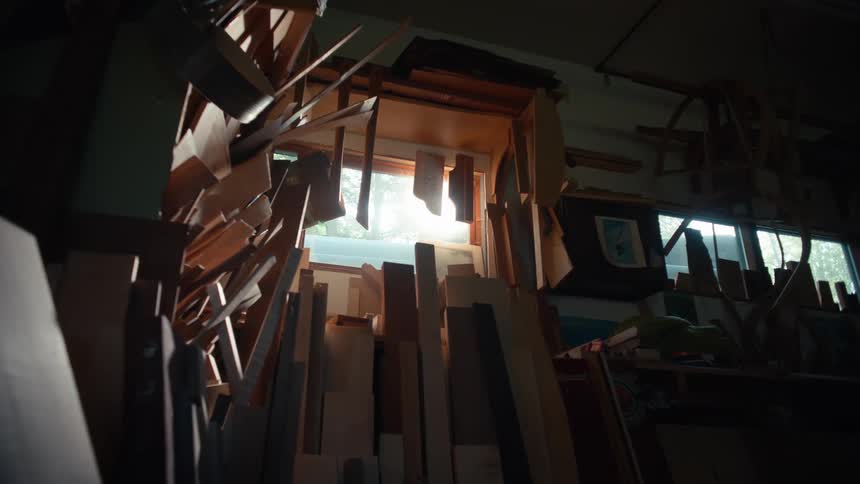 Various pieces of wood leaning against a wall in a wood workshop