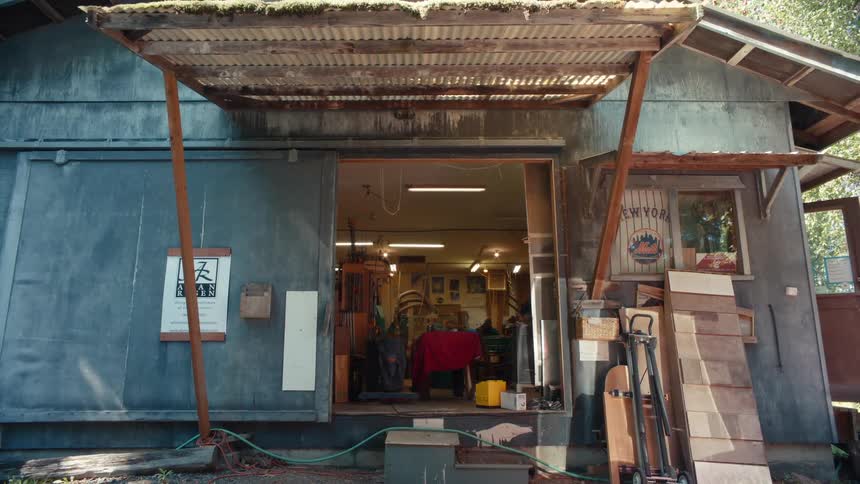 Entrance to a workshop with an open door and a man working