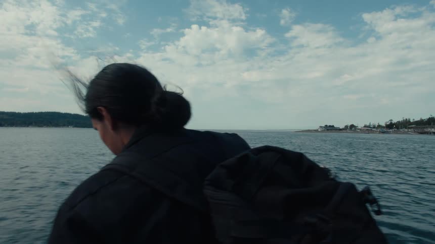 Man on a moving boat enjoying the sea scenery