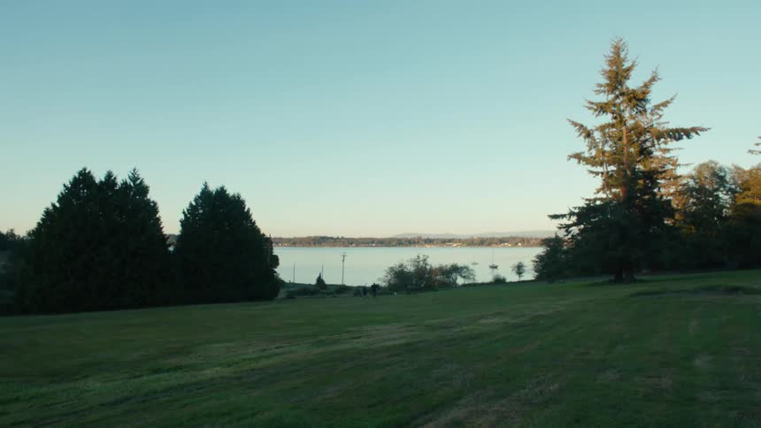 A vehicle drives past the water